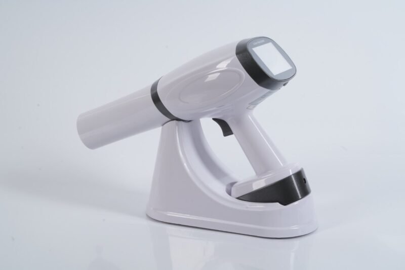 IDEN-X2 handheld dental X-ray unit with charging dock — touchscreen display visible