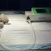 IWA-Ven10 small-animal and exotic veterinary ventilator i... IWA-Ven10 small-animal and exotic veterinary ventilator in clinical use - compact unit connected to a juvenile turtle / reptile patient on a recovery pad