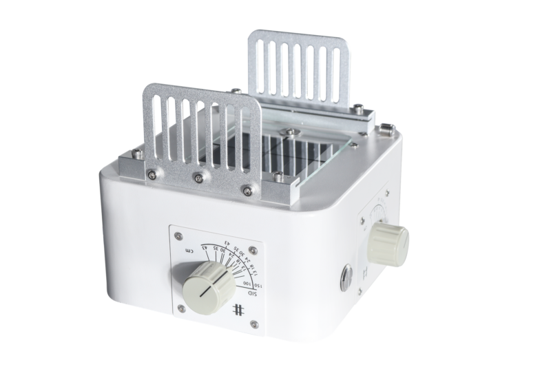 Manual X-ray collimator with mounting leaf plates raised, showing the field size scale marked 13, 18, 24, 30, 35 and 43 cm and SID settings of 100 and 150 cm