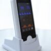 VE4 handheld monitor seated in the charging base, side profile showing the slim 29 mm body