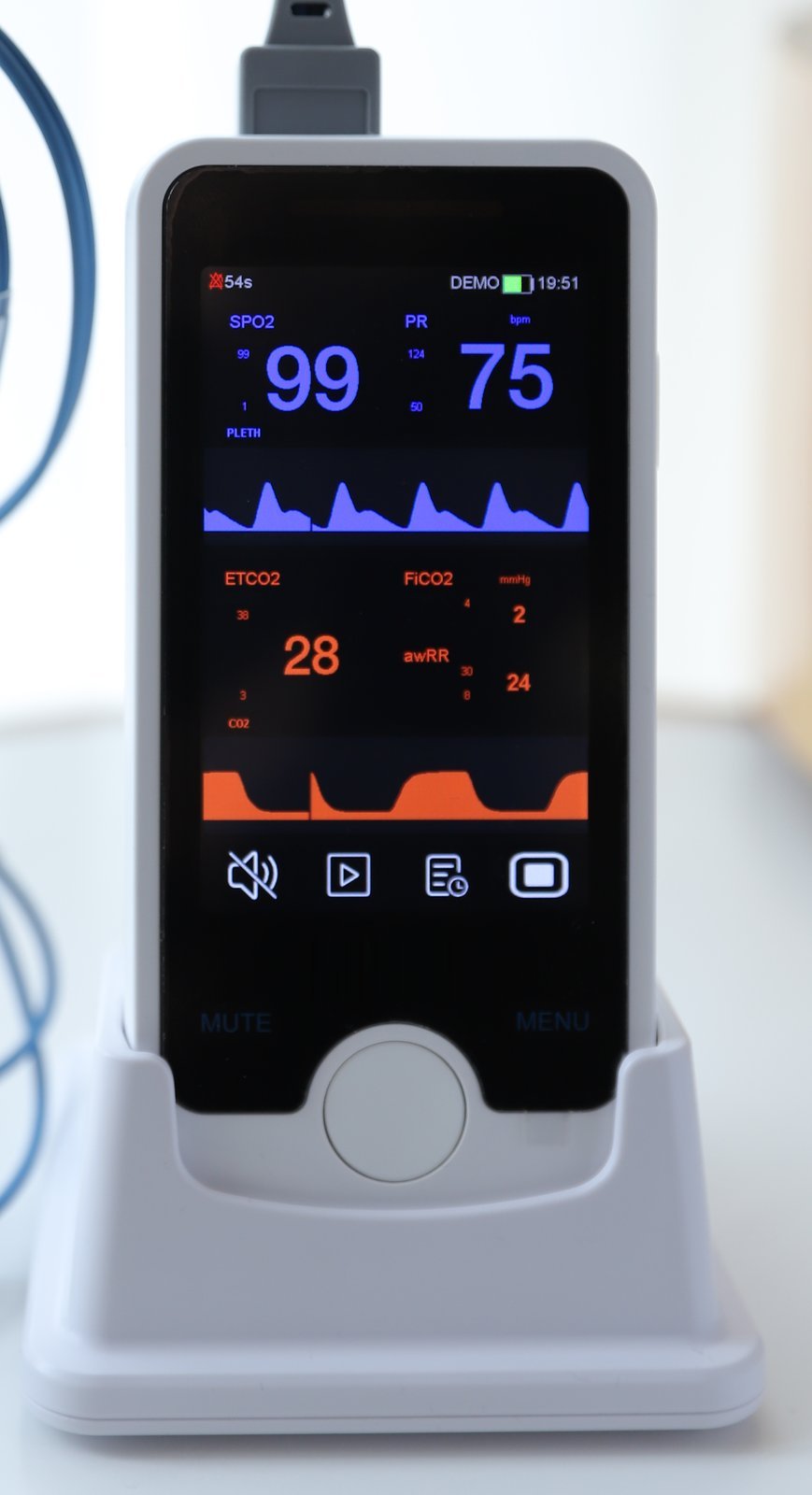 VE4 vital signs monitor docked in its charging base with the SpO2 sensor cable connected