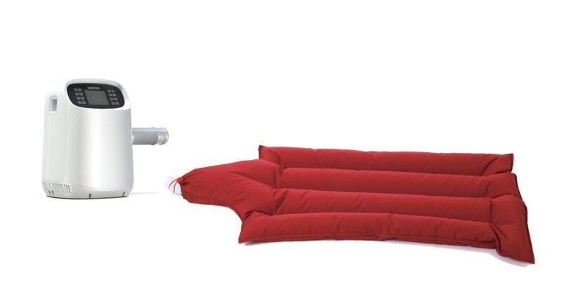 VHB warming unit connected by hose to a reusable inflatable warming blanket