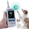 VM4 handheld pulse oximeter with SpO2 sensor cable, shown with canine and feline patients